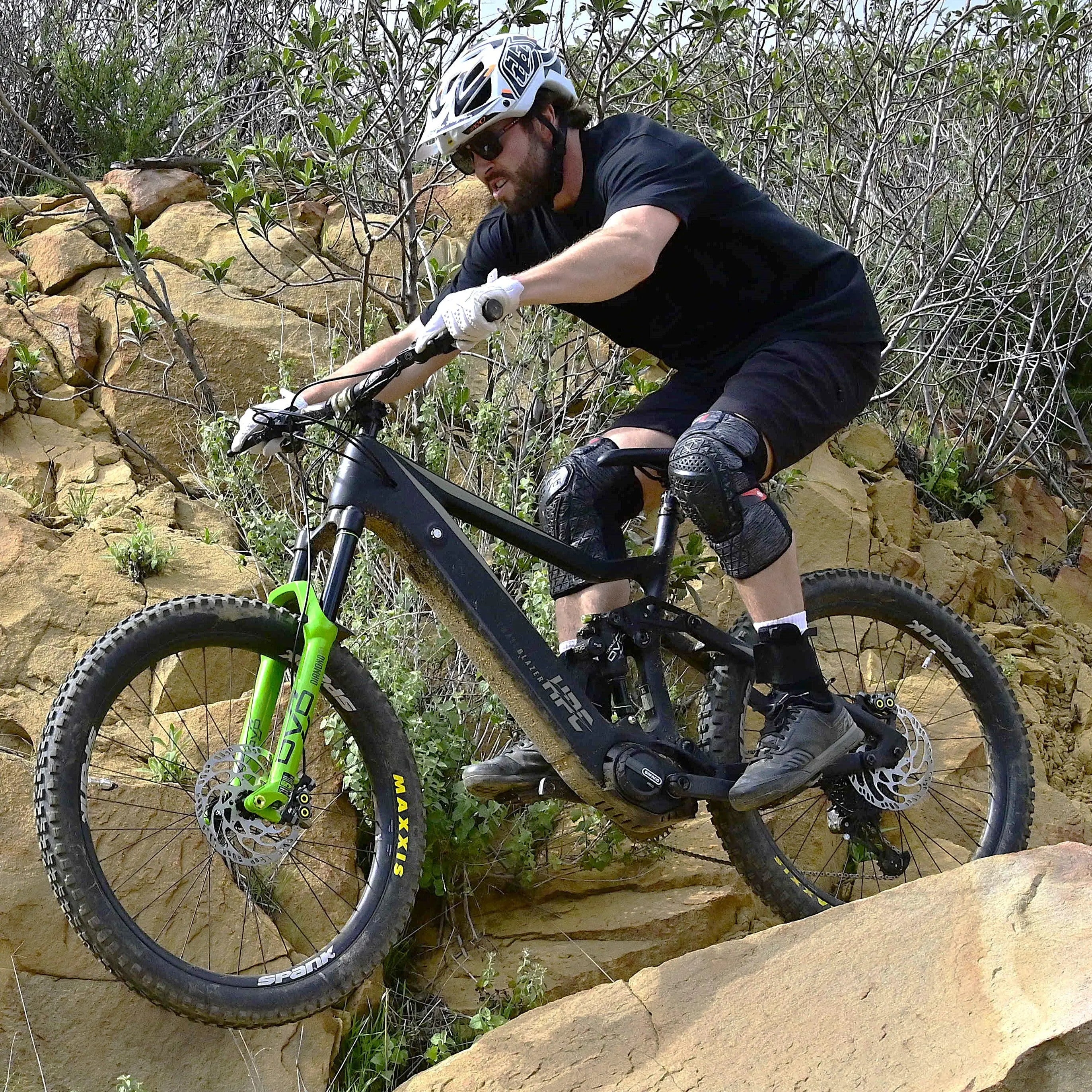 black enduro trailblazer e-bike going over rock jump